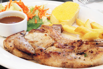 Grilled pork chop in white dish