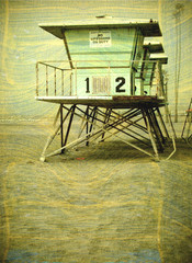 aged and worn vintage photo of lifeguard tower on beach