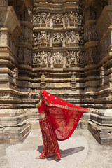 Woman's sari blowing in the wind, Khajuraho Temples, India.