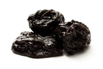 Prunes on the white background