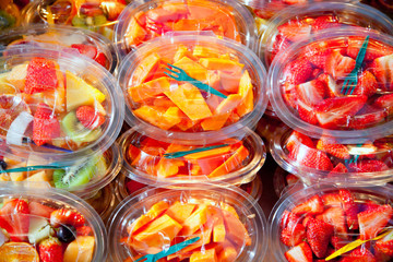 Colorful fruit salad in transparent glasses