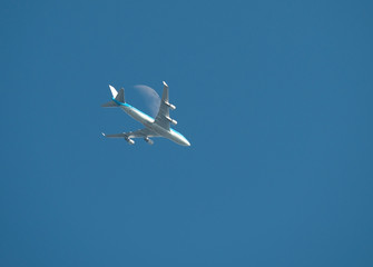 Airliner flying along the moon