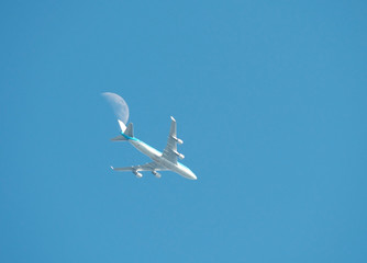 Airliner flying along the moon