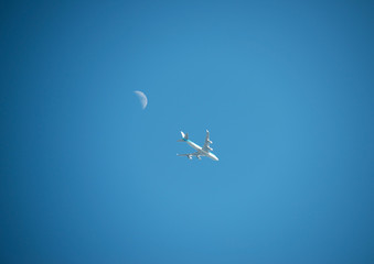 Airliner flying along the moon