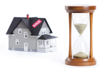 Sandglass in front of house architectural model