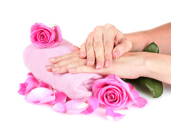 Pink towel with roses and hands on white background