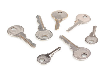 Many metal keys isolated on white
