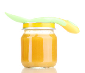 Jar of baby puree with spoon isolated on white