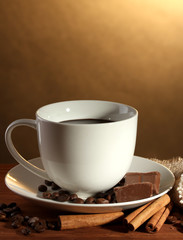 cup of coffee and beans, cinnamon sticks and chocolate
