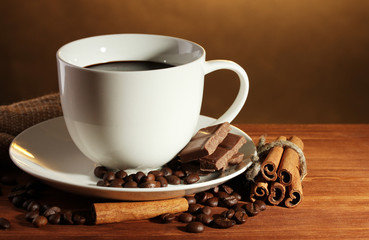 cup of coffee and beans, cinnamon sticks and chocolate