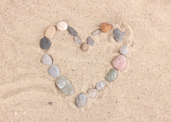 Fototapeta na wymiar Love-stones on sand