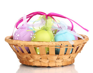 Colorful easter eggs in basket isolated on white