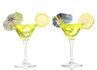 Yellow cocktail in martini glasses isolated on white