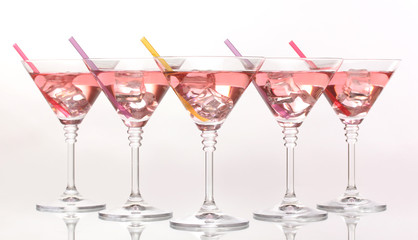 Red cocktail in martini glasses isolated on white