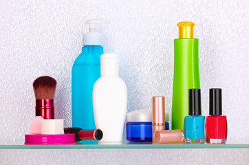 Shelf with cosmetics and toiletries in bathroom