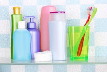 Shelf with cosmetics and toiletries in bathroom