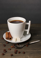 Coffee cup on wooden table on grey background