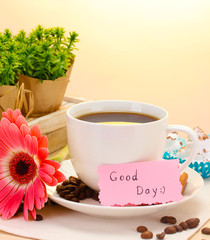 cup of coffee and gerbera  beans, cinnamon sticks
