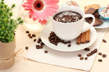 cup of coffee and gerbera  beans, cinnamon sticks