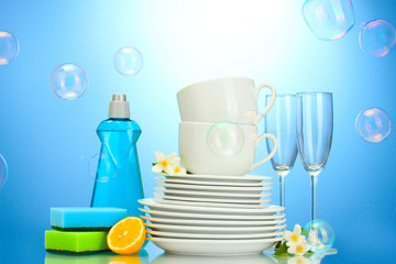 empty clean plates, glasses and cups with dishwashing liquid,