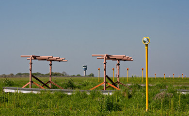 Airport landing lights with control tower in bacckground