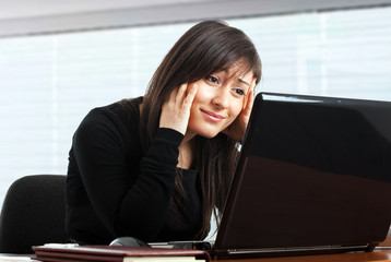 Stressed businesswoman at her desk