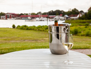 Ice bucket with champagne and glass