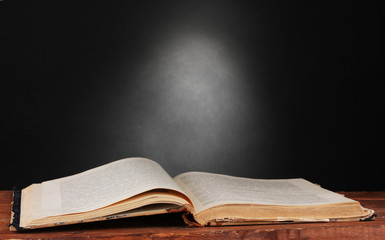 old book on wooden table on gray background