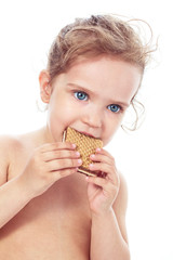 Beautiful sweet  little girl eating a cookie