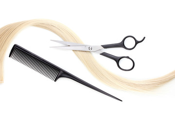 Shiny blond hair with hair cutting shears and comb isolated
