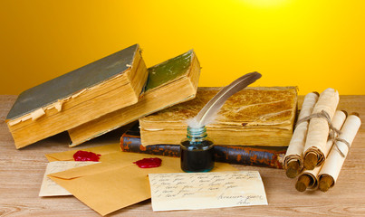 old books, scrolls, feather pen and inkwell