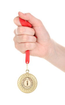 Gold Medal In Hand Isolated On White