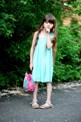 Fototapeta premium Portrait of child girl in turquoise dress