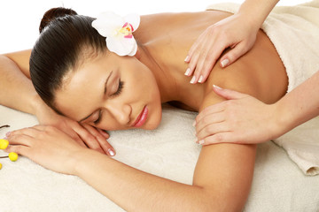 A beautiful woman getting massage in a spa center