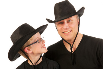 man and child with cowboy hats