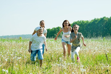 Friends running in meadow