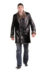 Studio photo of trendy young man walking on white background