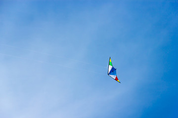 Fototapeta na wymiar colorful kite soaring in a nice blue sky