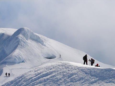 Climbers on edge of crater of volcano Beerenberg, Jan Mayen