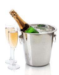 Champagne bottle in bucket with ice and glasses of champagne,