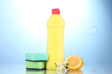 Dishwashing liquid with sponges and lemon with flowers