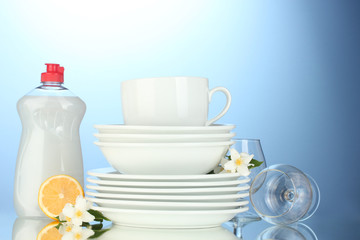 empty clean plates, glasses and cups with dishwashing liquid