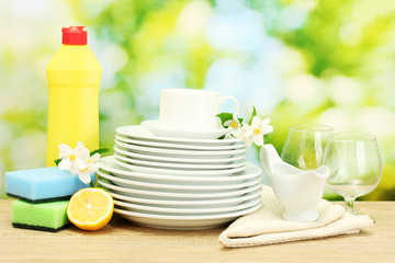 empty clean plates, glasses and cups with dishwashing liquid