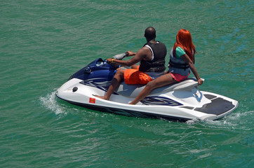 Afro-American Couple Riding on a Jet Ski