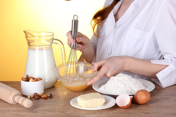 Female hands mixing eggs in bowl