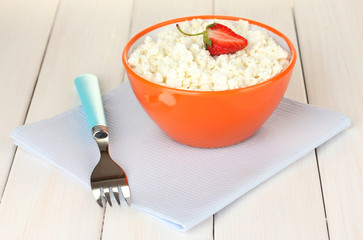 cottage cheese with parsley in orange bowl and fork