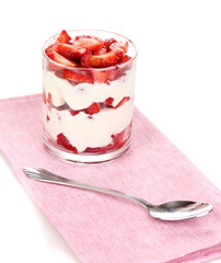 Glass of ripe strawberries with cream isolated on white