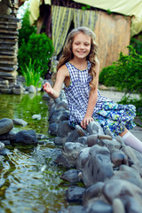 smiling little girl having fun playing with water in garden