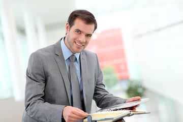 Businessman looking at meeting dates on agenda