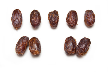 Medjool dates isolated on a white studio background.
